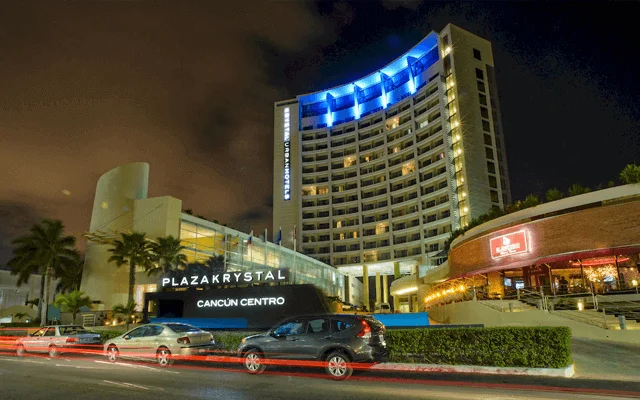 Cancun Downtown hotel with blue lights at night. One of the destinations available for Cancun Airport Transportation